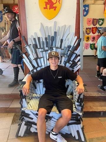 image of Aidan in a chair of swords