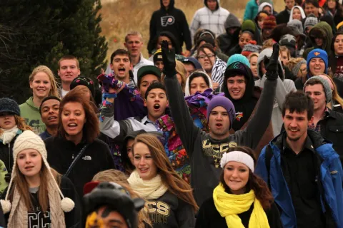 Students participate in 'The March' to tailgating for homecoming.