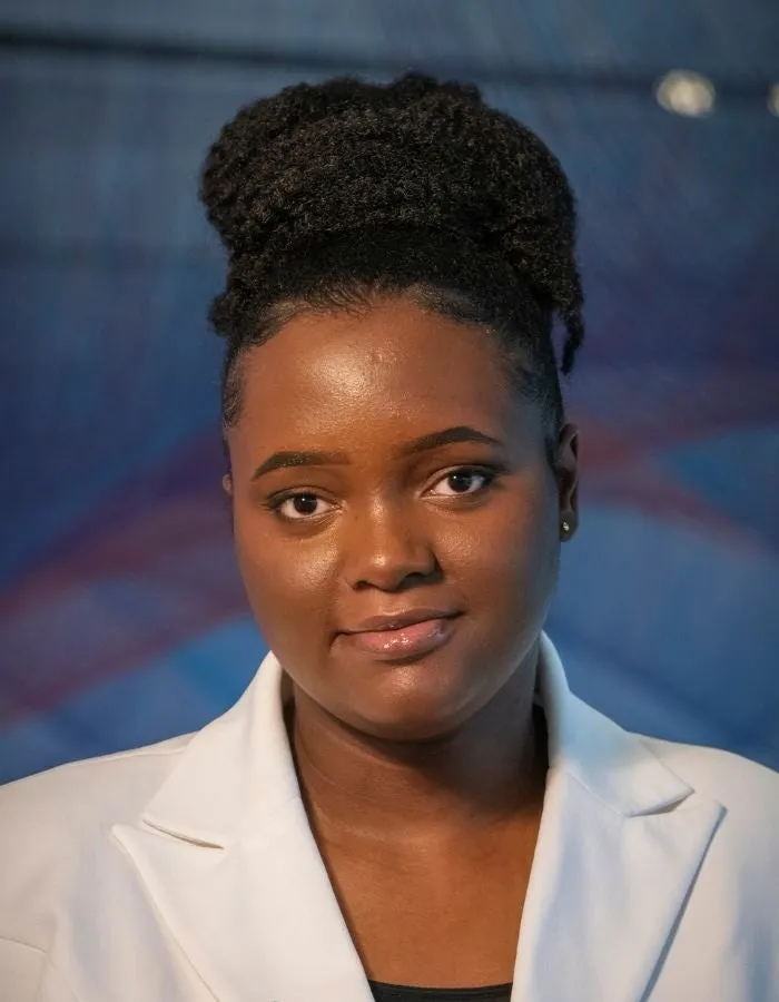 Image of Celine Habimana, a person wearing a white blazer.