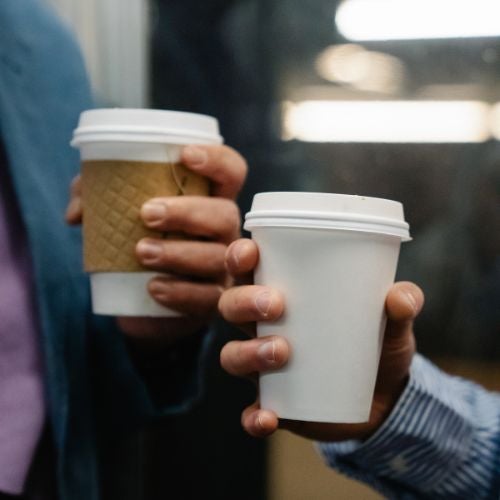 people holding coffee cups